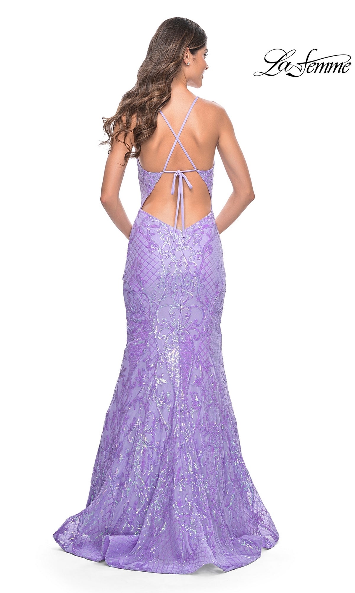 A woman wears the La Femme Long Sequin Mermaid Prom Dress 32337—floor-length, lavender, fitted with sequin print, open back, and crisscross straps. The La Femme brand appears in the top right corner.